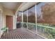 Relaxing screened porch with wood decking and lush greenery at 290 Valencia Cir, St Petersburg, FL 33716