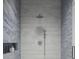 Walk-in shower with grey wood-look tile and a rain shower head at 3801 71St N St, St Petersburg, FL 33709