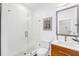 Modern bathroom with a glass shower, white wave patterned walls, and wood vanity at 460 87Th Avenue North, St Petersburg, FL 33702