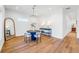 Bright dining area with a round table and four chairs, hardwood floors, and modern light fixture at 460 87Th Avenue North, St Petersburg, FL 33702