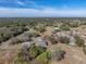 Aerial view of a house nestled in a quiet neighborhood with lush green surroundings at 5364 Boxtree Ct, Dade City, FL 33523