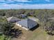 New single-story house aerial view, gray roof, white walls, and a large backyard at 5364 Boxtree Ct, Dade City, FL 33523