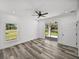 Spacious bedroom with vinyl plank flooring and sliding glass doors leading to the backyard at 5364 Boxtree Ct, Dade City, FL 33523