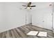 Bedroom with ceiling fan and grey wood-look floors at 5364 Boxtree Ct, Dade City, FL 33523