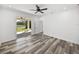 Bright bedroom with vinyl plank flooring and sliding glass doors leading to the backyard at 5364 Boxtree Ct, Dade City, FL 33523