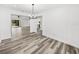 Bright dining room features wood-look flooring and a modern chandelier at 5364 Boxtree Ct, Dade City, FL 33523