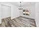 Simple dining area with vinyl plank flooring and a modern chandelier at 5364 Boxtree Ct, Dade City, FL 33523