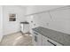 Bright laundry room features white cabinets, granite countertops, and ample shelving at 5364 Boxtree Ct, Dade City, FL 33523