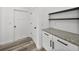 Laundry room with white cabinets and granite countertop at 5364 Boxtree Ct, Dade City, FL 33523