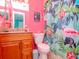 Bathroom features flamingo decor and a floral shower curtain at 5605 Shore S Blvd # B, Gulfport, FL 33707