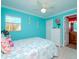 Bedroom with teal walls, a comfy bed, and dresser at 5605 Shore S Blvd # B, Gulfport, FL 33707