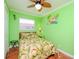 Bedroom with green walls, a ceiling fan and a leafy bedding set at 5605 Shore S Blvd # B, Gulfport, FL 33707