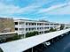 Aerial view of condo building with parking and landscaping at 4910 Bay Ne St # 309, St Petersburg, FL 33703