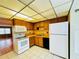 Kitchen with wood cabinets, white appliances, and tile floor at 4910 Bay Ne St # 309, St Petersburg, FL 33703
