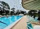 Community pool with lounge chairs and umbrellas at 4910 Bay Ne St # 309, St Petersburg, FL 33703