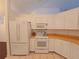 Kitchen with white appliances and ample cabinet space at 10232 Oakhurst Rd, Largo, FL 33774