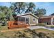 Cute bungalow with a screened porch and a deck, perfect for relaxing outdoors at 1100 E Louisiana Ave, Tampa, FL 33603