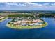 Aerial view of Community Center featuring multiple pools, tennis courts and lake views at 16233 Amethyst Key Dr, Wimauma, FL 33598