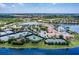Expansive aerial view of community amenities, featuring tennis courts and clubhouse with a large pool, all set against a backdrop of homes at 16233 Amethyst Key Dr, Wimauma, FL 33598