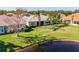 Home's manicured backyard and mature landscaping adjoins a tranquil lake with fountains at 16233 Amethyst Key Dr, Wimauma, FL 33598