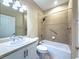 Bright bathroom featuring a shower-tub combo with beige tile and a white vanity with a light countertop at 16233 Amethyst Key Dr, Wimauma, FL 33598