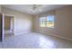 Well-lit bedroom with scenic lake view from window and neutral-toned walls with tile flooring at 16233 Amethyst Key Dr, Wimauma, FL 33598