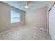 Bright bedroom with neutral walls, tile flooring, closet, and natural light, creating a serene atmosphere at 16233 Amethyst Key Dr, Wimauma, FL 33598