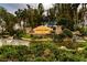 Sign for Valencia Lakes gated community with lush landscaping and water features at 16233 Amethyst Key Dr, Wimauma, FL 33598