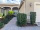 Charming front exterior with manicured landscaping and a brick walkway leading to the front door at 16233 Amethyst Key Dr, Wimauma, FL 33598