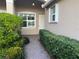Inviting front entrance with a brick walkway framed by lush landscaping and an attractive exterior at 16233 Amethyst Key Dr, Wimauma, FL 33598