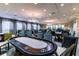 Bright game room with poker tables, and comfortable seating at 16233 Amethyst Key Dr, Wimauma, FL 33598