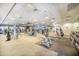Bright gym features multiple machines and free weights for residents to utilize at 16233 Amethyst Key Dr, Wimauma, FL 33598