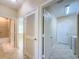 Hallway featuring doorways to other rooms, offering a glimpse of the home's layout and design at 16233 Amethyst Key Dr, Wimauma, FL 33598