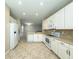 Spacious kitchen with stainless steel appliances, ample cabinet space, and tile flooring throughout the area at 16233 Amethyst Key Dr, Wimauma, FL 33598