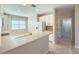 Open-concept kitchen features a large island, stainless steel appliances, and tile flooring in a bright space at 16233 Amethyst Key Dr, Wimauma, FL 33598