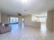 Expansive living room features tile floors and a seamless transition into the open-concept kitchen at 16233 Amethyst Key Dr, Wimauma, FL 33598