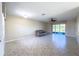 Large living room with tile flooring, a ceiling fan, and sliding glass doors to the lanai at 16233 Amethyst Key Dr, Wimauma, FL 33598
