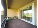 Relaxing screened patio offers serene lake view, stylish brick flooring, and comfortable outdoor space at 16233 Amethyst Key Dr, Wimauma, FL 33598