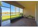 Screened lanai boasts brick floors, outdoor plants, and a peaceful view of the lake at 16233 Amethyst Key Dr, Wimauma, FL 33598