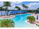 Resort-style pool with blue canopies, comfortable seating, and picturesque views of the surrounding lake for a serene experience at 16233 Amethyst Key Dr, Wimauma, FL 33598