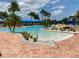 Inviting pool area showcasing a shallow end with lush landscaping, perfect for relaxation in a tranquil and scenic environment at 16233 Amethyst Key Dr, Wimauma, FL 33598
