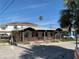 Charming single story home with covered porch and a palm tree nearby at 102 87Th Ave, Treasure Island, FL 33706