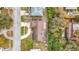 Aerial view of a house with a driveway and surrounding trees at 1557 Jeffords St, Clearwater, FL 33756