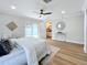 Bright bedroom with a queen bed, wood floors, and access to a private bathroom at 1557 Jeffords St, Clearwater, FL 33756