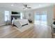 Spacious bedroom with a queen bed, wood floors, and sliding glass doors to backyard at 1557 Jeffords St, Clearwater, FL 33756