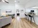 Bright living room with hardwood floors, comfy seating, and a view into the kitchen at 1557 Jeffords St, Clearwater, FL 33756