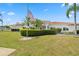 Well-manicured building exterior featuring lush landscaping and a red tile roof at 4415 96Th N Ave, Pinellas Park, FL 33782