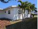 Exterior home view with lush, mature landscaping and trees on a sunny day at 4415 96Th N Ave, Pinellas Park, FL 33782