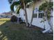 Exterior view of the white house, showcasing well-maintained landscaping and palm trees at 4415 96Th N Ave, Pinellas Park, FL 33782