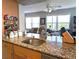 Granite countertops and a stainless sink add luxury to this open kitchen layout at 4415 96Th N Ave, Pinellas Park, FL 33782